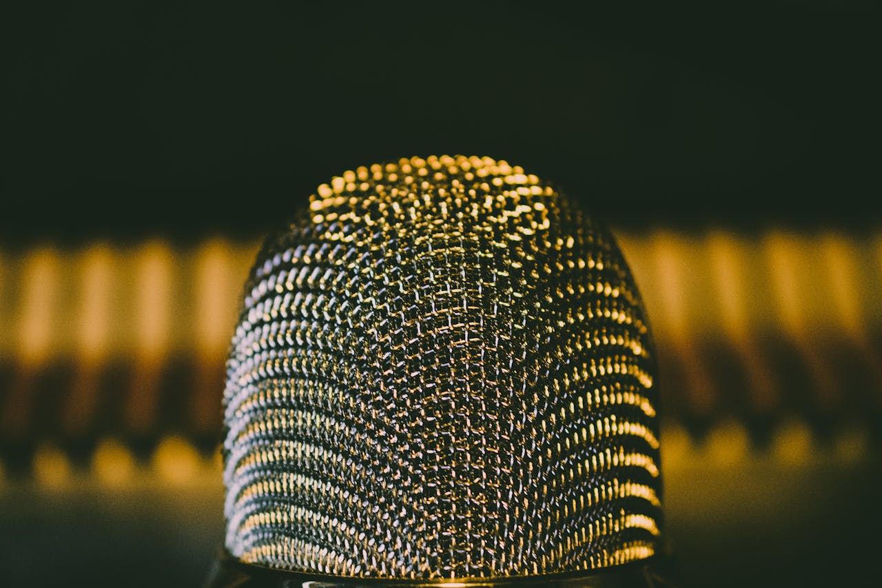 A detailed close-up shot of a modern microphone with a bokeh background, perfect for audio equipment themes.